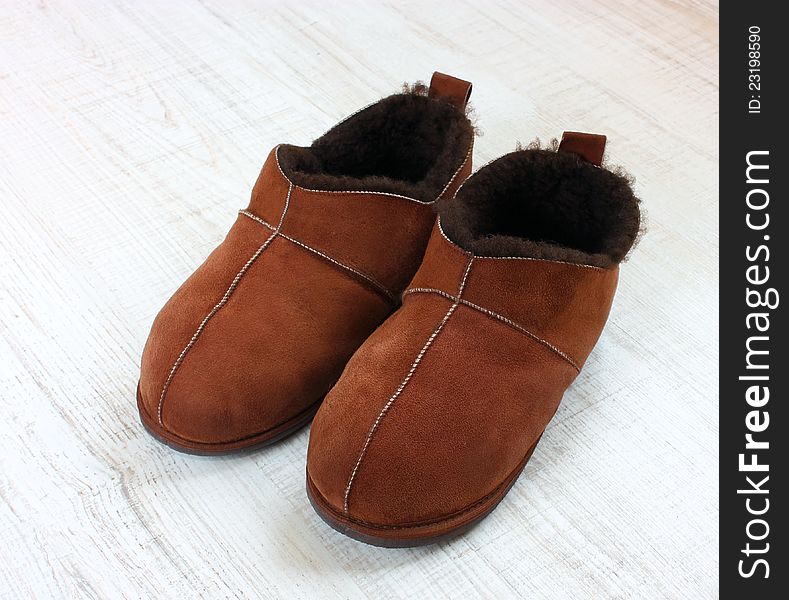 Male slippers made from leather on a floor