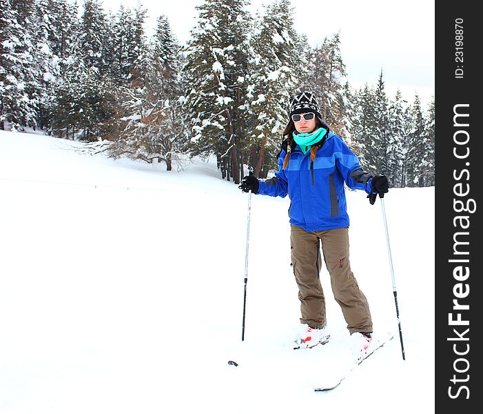 Young beautiful woman skiing outdoor in a snow covered mountain. Young beautiful woman skiing outdoor in a snow covered mountain