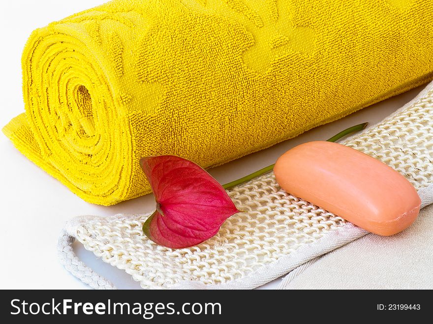 Yellow towel, soap and washcloth