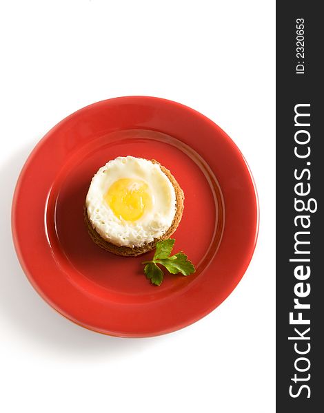 Fried egg on red dish