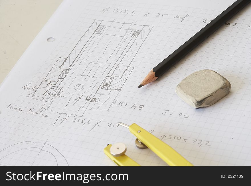 Engineering drawing on drawing desk with rubber and pencil