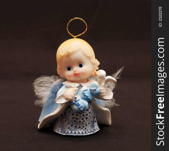 Small toy angel as a souvenir for an ornament. Small toy angel as a souvenir for an ornament