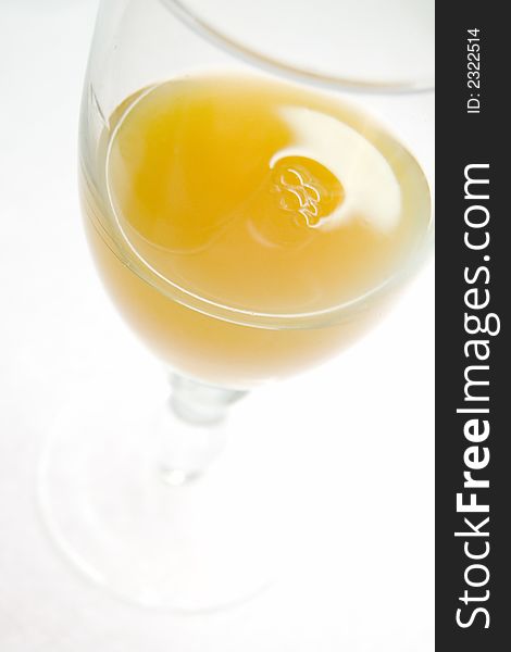 Wineglass with orange juice, liquid, closeup. Wineglass with orange juice, liquid, closeup