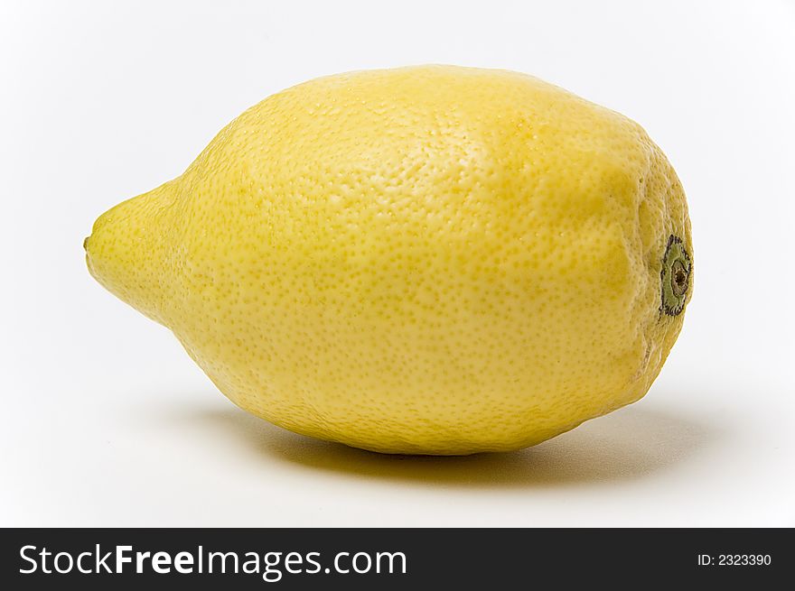 A yellow lemon shot against a white background