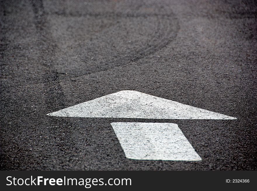 Directional arrown on black asphalt road. Directional arrown on black asphalt road