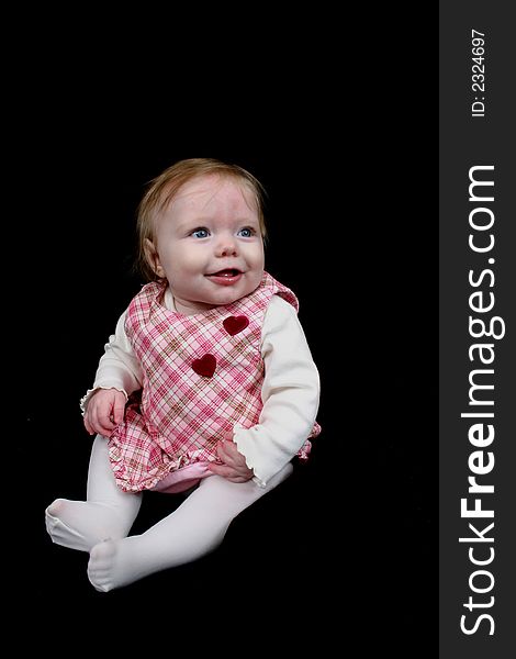 Cute little girl on black background