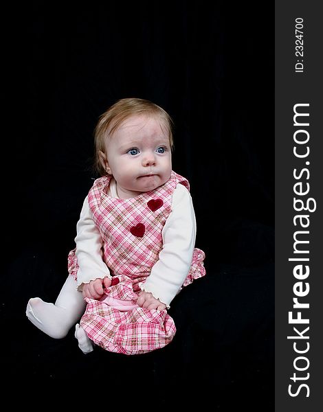 Cute little girl on black background