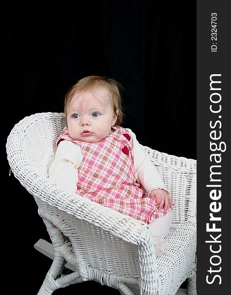 Cute little girl on black background