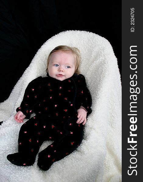 Cute little girl on black background