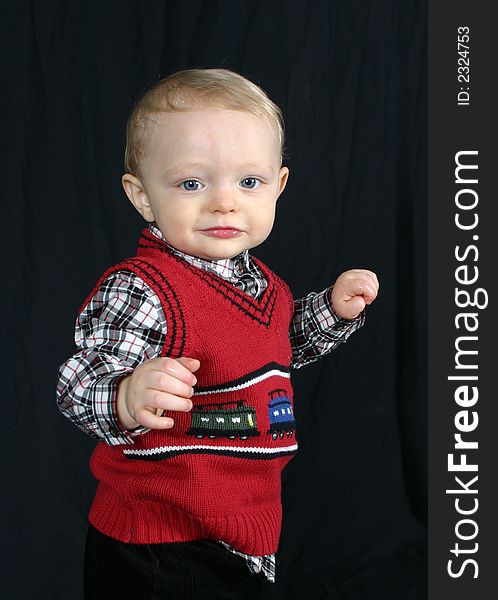 Cute little boy on black background