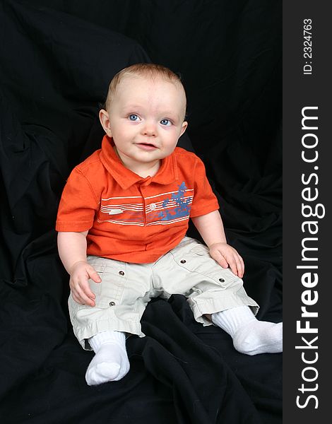 Cute little boy on black background