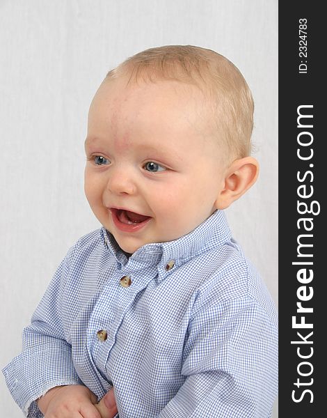 Cute little boy smiling on a white background