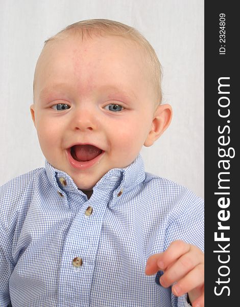 Cute little boy smiling on a white background