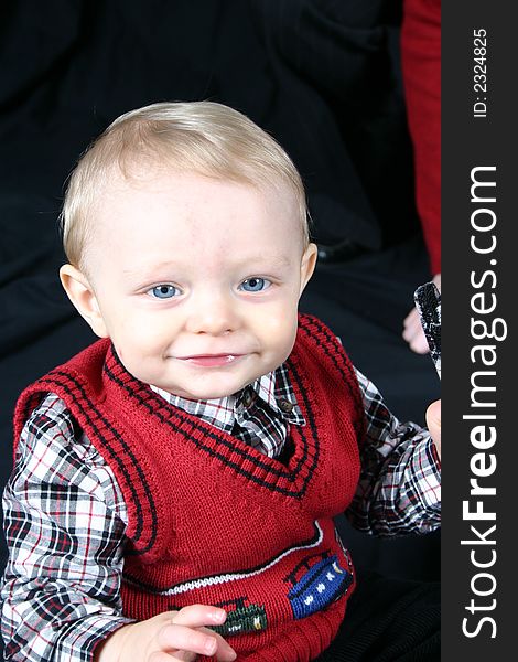 Cute little boy smiling on a black background