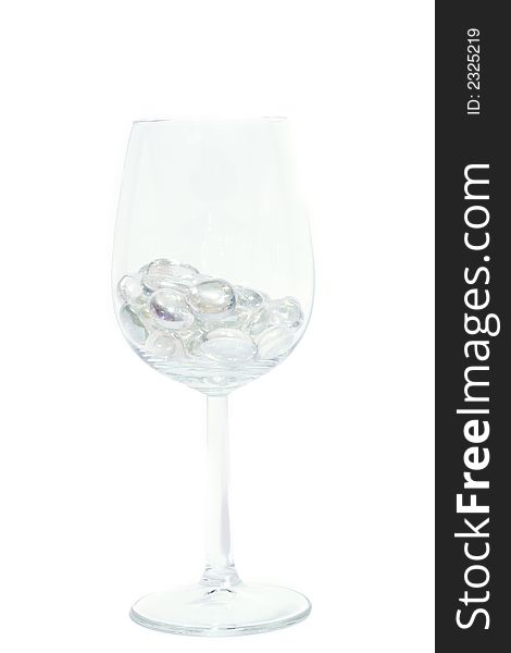 Sparkling stones in a wine glass isolated on white. Sparkling stones in a wine glass isolated on white