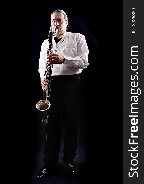 A man playing his wind instrument with expression. A man playing his wind instrument with expression.