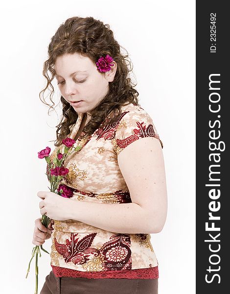 Beautiful young woman poses with red flowers