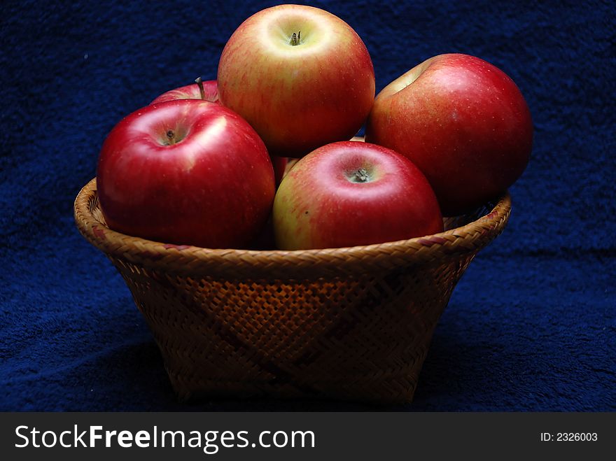 Basket whit apples on dark background