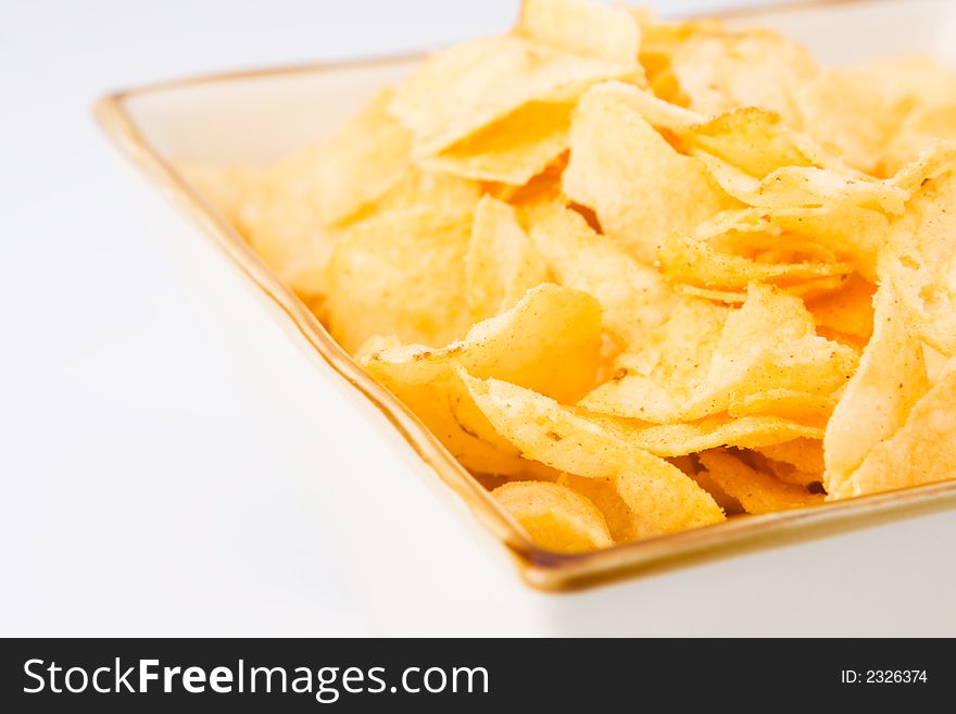 Chips in a square bowl with a white background