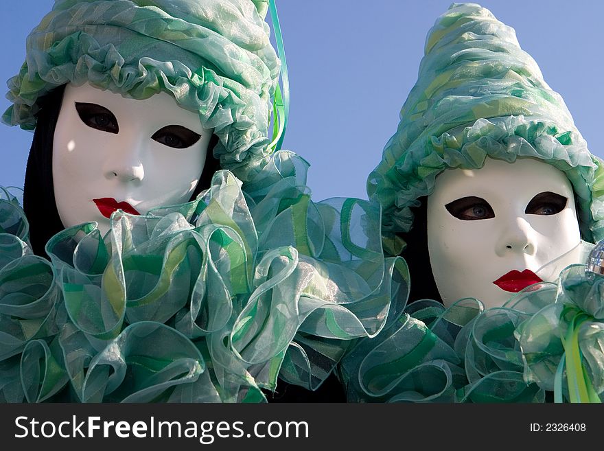 Two women in turquoise costumes at the Venice Carnival. Two women in turquoise costumes at the Venice Carnival