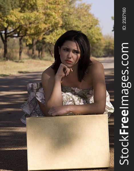 Sad Brunette With Suitcase