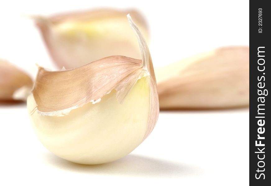 Close-up of a clove of garlic on a white background.