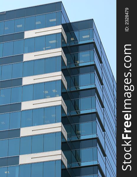 A Blue Glass Building against a  blue sky