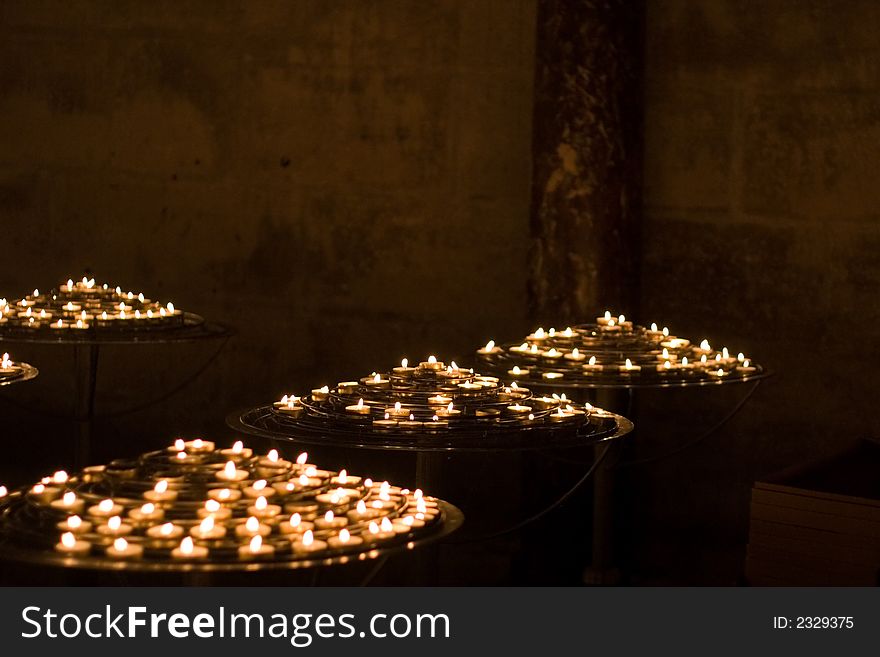 Candles in a circular pattern in the church of Notre Dame, Paris, France, with a narrow depth of field