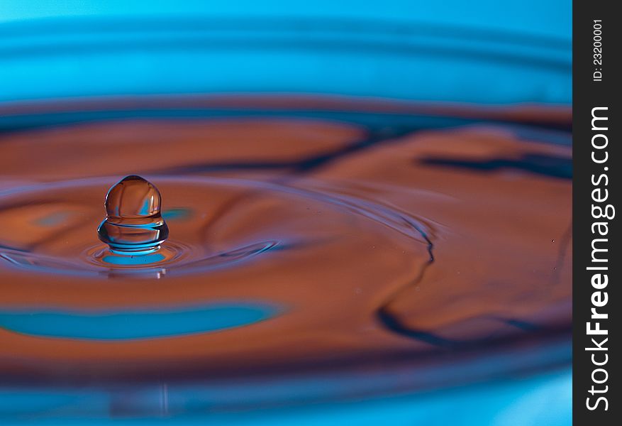 Droplet Falling In The Glass Of Water