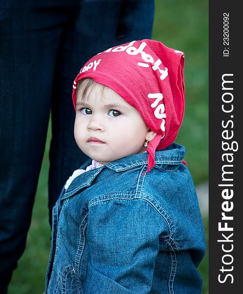 Little girl wearing jeans and red scarf