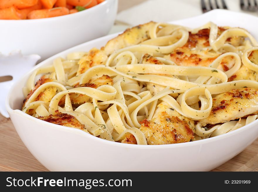 Chicken and noodle meal in a serving bowl. Chicken and noodle meal in a serving bowl