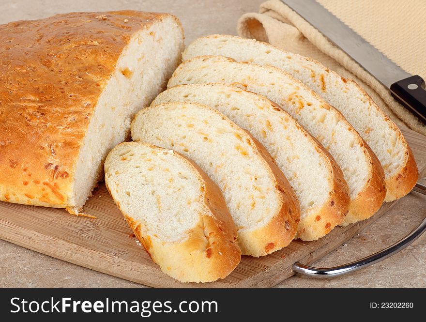 Sliced cheddar cheese bread on a cutting board. Sliced cheddar cheese bread on a cutting board