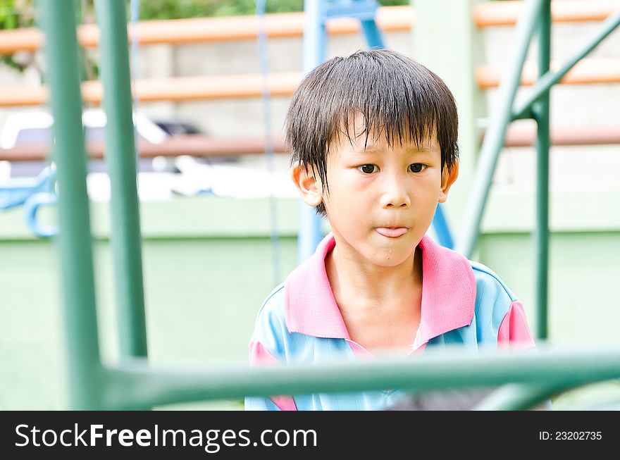 Asian boy attend playing outdoor and show his mouth