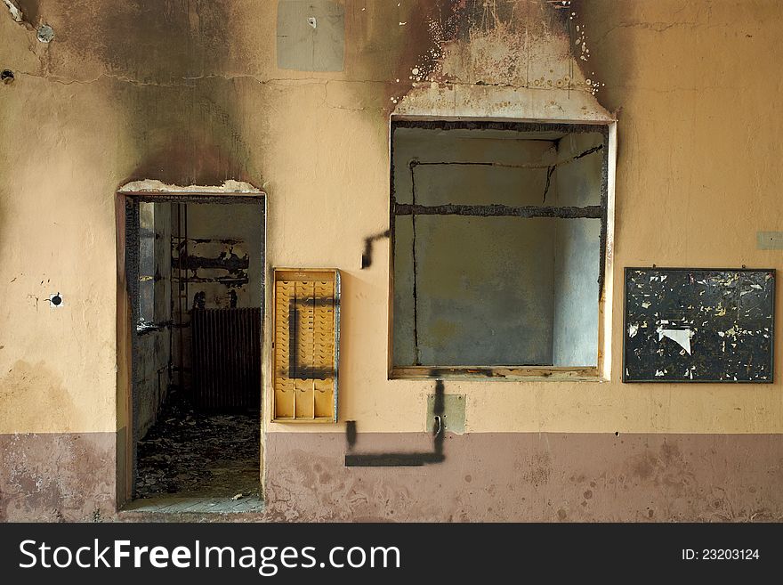 Fire damaged room. Black burnt out wood. Pstel pinted walls. Dramatic light. Photo taken witl Leica M9. Fire damaged room. Black burnt out wood. Pstel pinted walls. Dramatic light. Photo taken witl Leica M9.