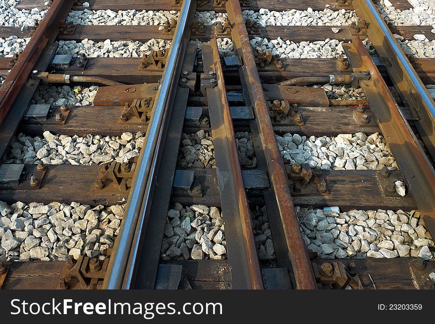 A set of train tracks crossing paths. A set of train tracks crossing paths.