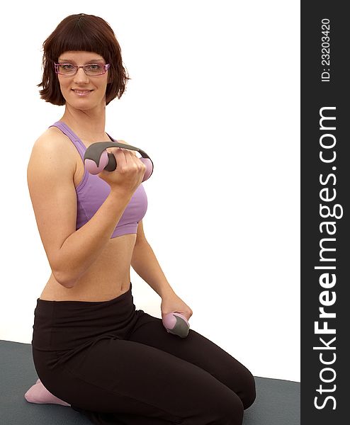Beautiful young woman doing exercises. White background.