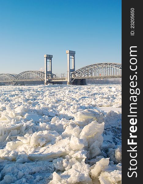 Bridge over frozen river in sunny day