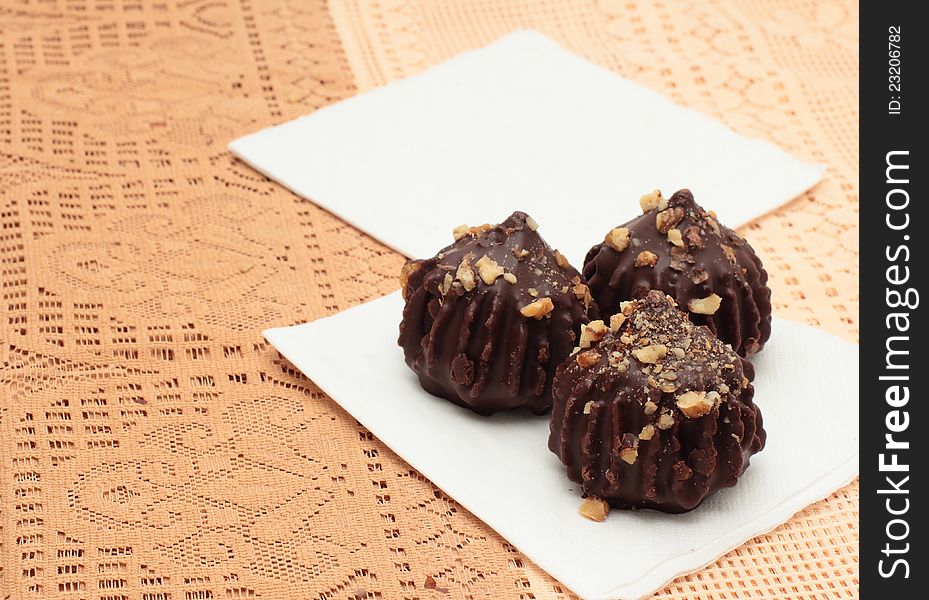 Chocolate truffle cakes with peanuts on napkins