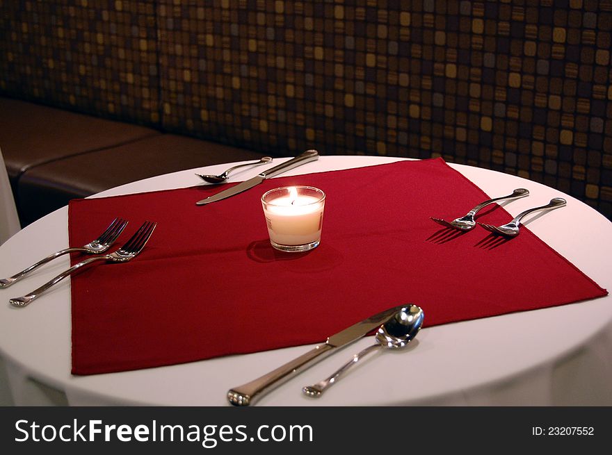 A candle lit set dinner table for two. A candle lit set dinner table for two.