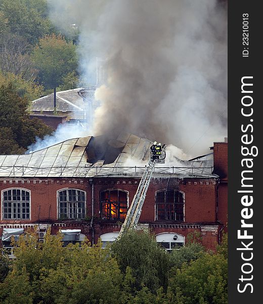 Firefighters extinguish a burning building. Firefighters extinguish a burning building