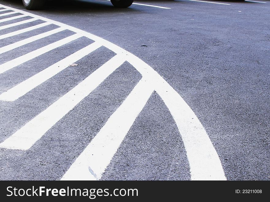 White markings on asphalt at car park area.