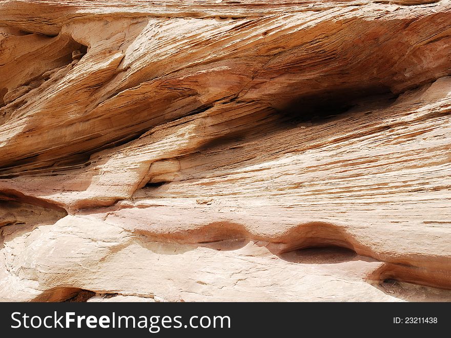 A Span of rock wall with lines and crevasses. A Span of rock wall with lines and crevasses