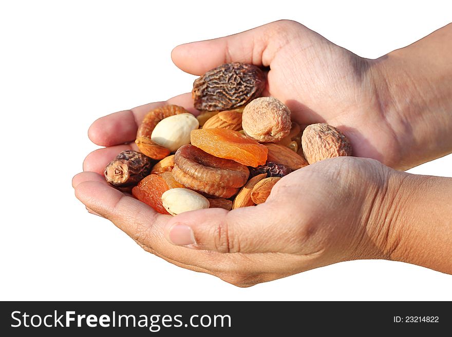 Bunch of dry fruits in a woman's hand. Dry fruits like almonds, raisins, dates and apricots isolated on white. Bunch of dry fruits in a woman's hand. Dry fruits like almonds, raisins, dates and apricots isolated on white