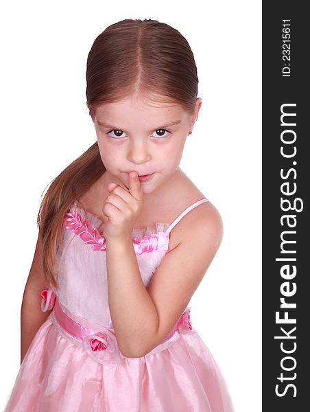 Studio portrait of a beautiful little girl laying a finger on her mouth. Studio portrait of a beautiful little girl laying a finger on her mouth