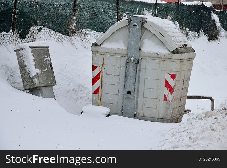 Trash can in the snow in winter