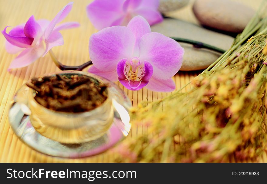 Purple orchid and dried cloves with St. Johns and rocks for spa treatment. Purple orchid and dried cloves with St. Johns and rocks for spa treatment.