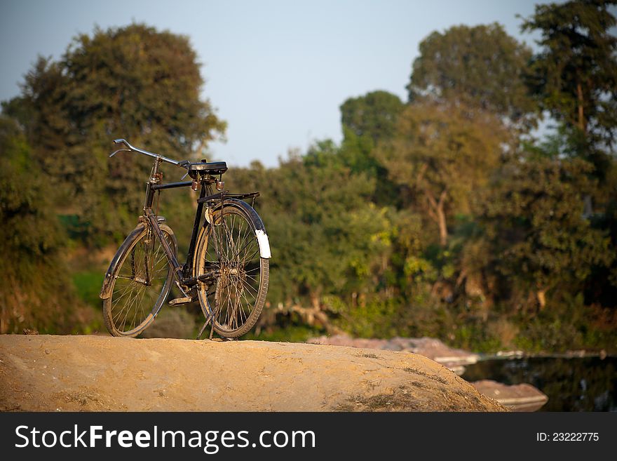 Bicycle parked on a park over blurred natural background. Bicycle parked on a park over blurred natural background