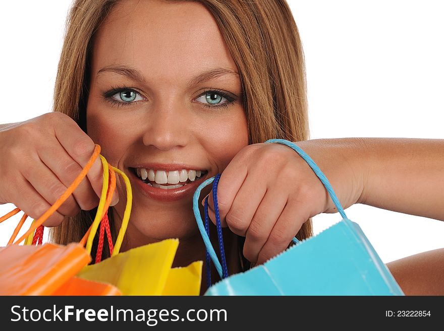 Young woman's portrait with colorful shopping bags isolated on a white background. Young woman's portrait with colorful shopping bags isolated on a white background