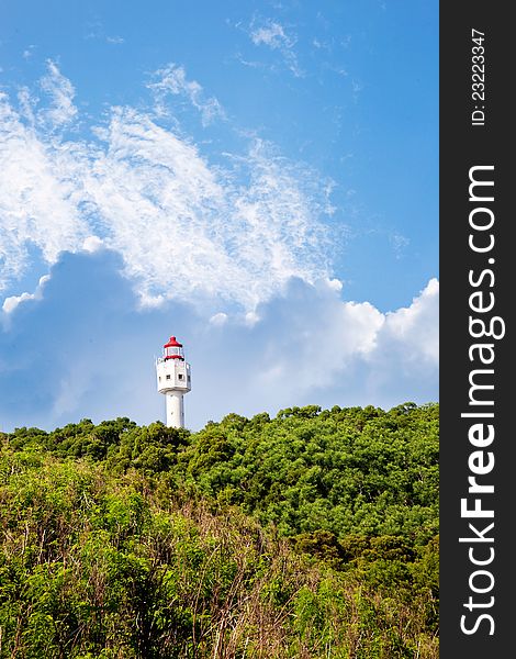 Lighthouse with blue sky white clouds