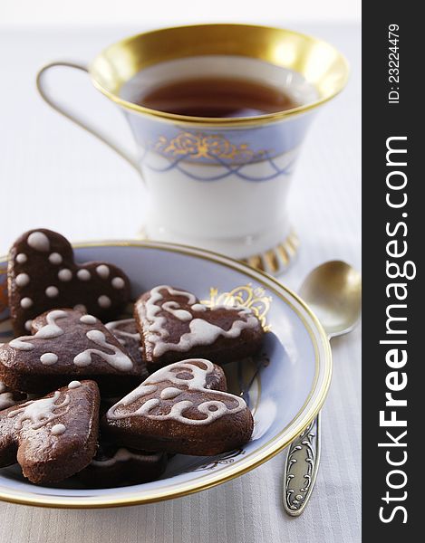 Fresh tasty heart shaped honey breads with a cup of tea